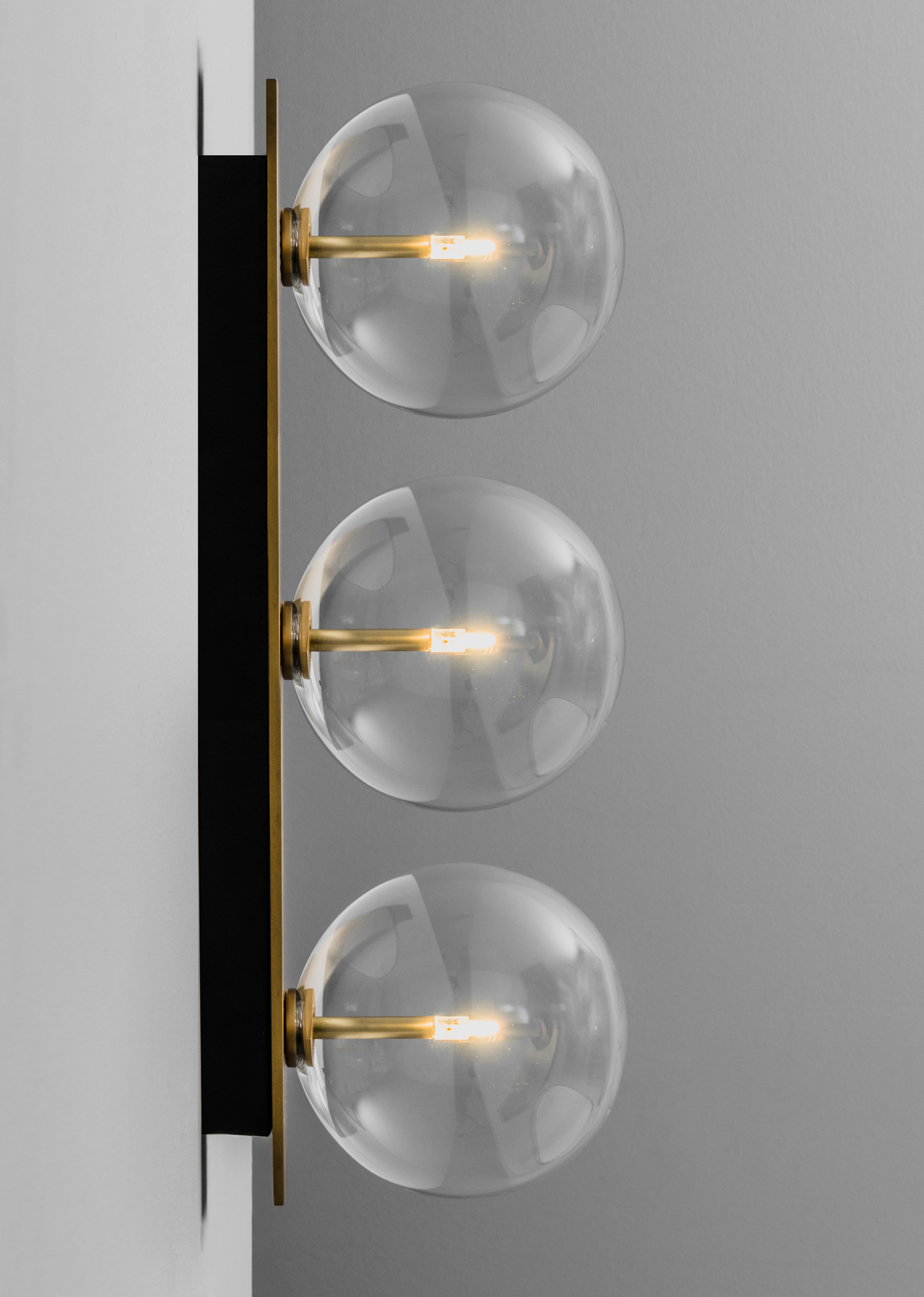 Schwung Oslo Triple Burnished Brass Transparent Globe Wall Light